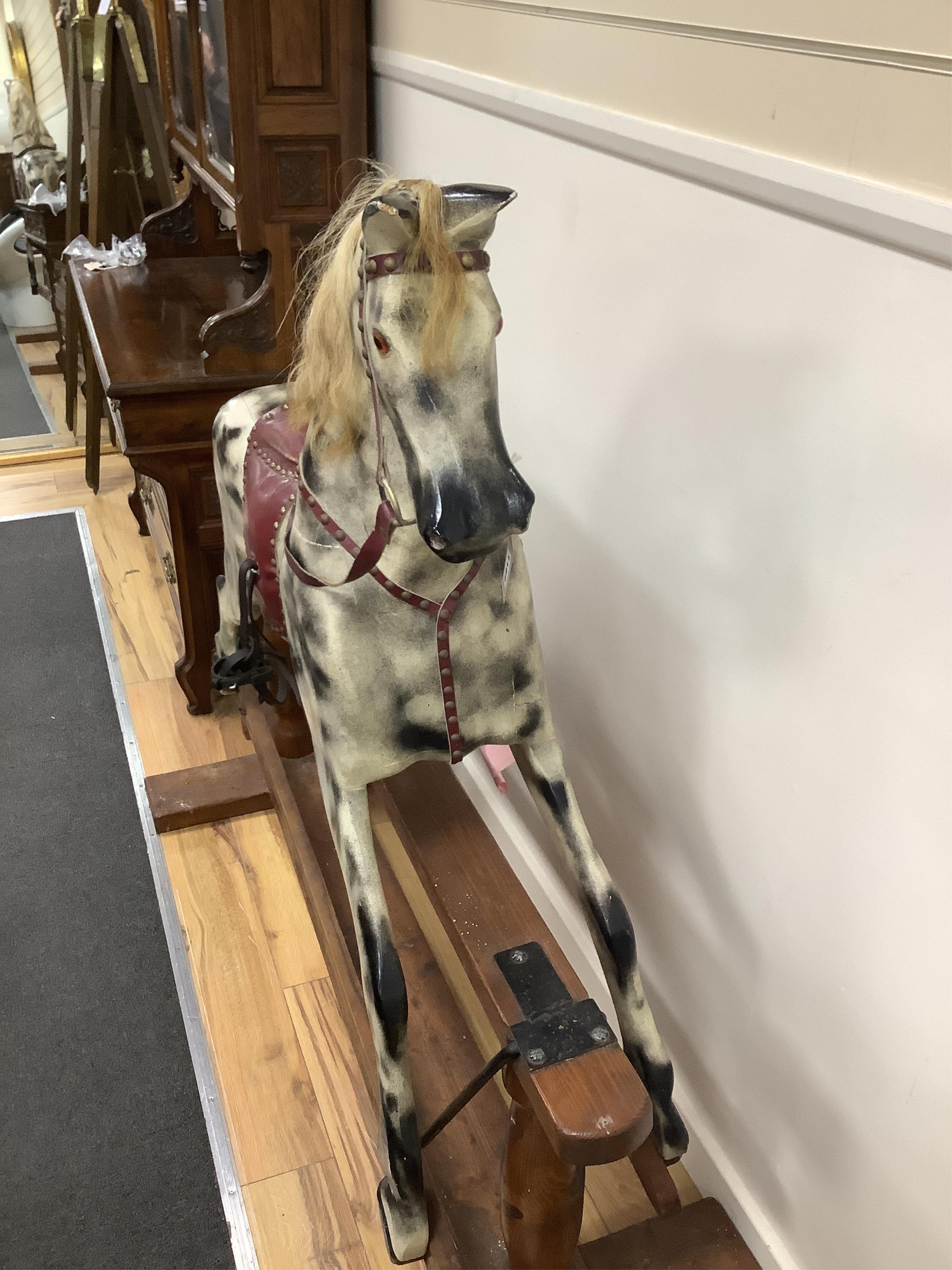 A large mid 20th century dapple grey rocking horse, on pine safety frame, length 168cm, height 135cm. Condition - fair